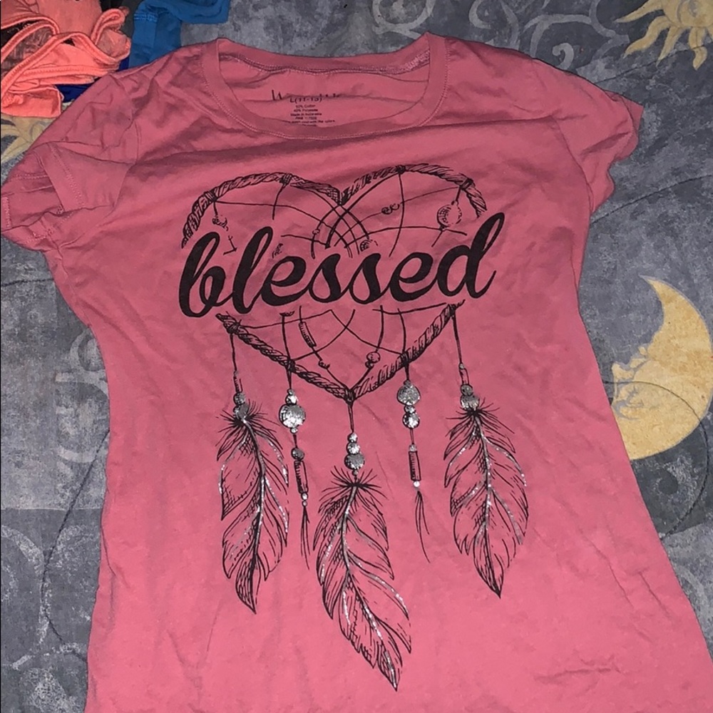 This is a cute pinkish colored shirt.